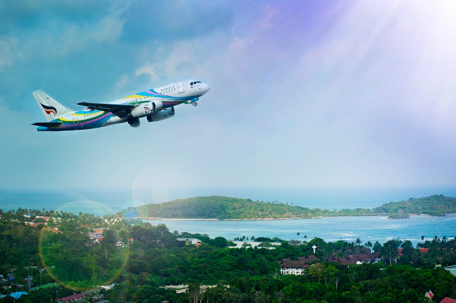 Airplane soaring over Koh Samui island, Thailand, showcasing a vibrant tropical landscape in daylight